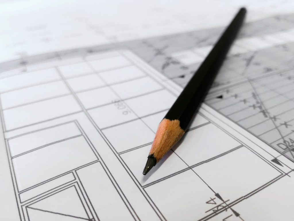 pexels-photo-268362 Detailed image of a black pencil resting on architectural blueprints, ideal for design and planning themes.