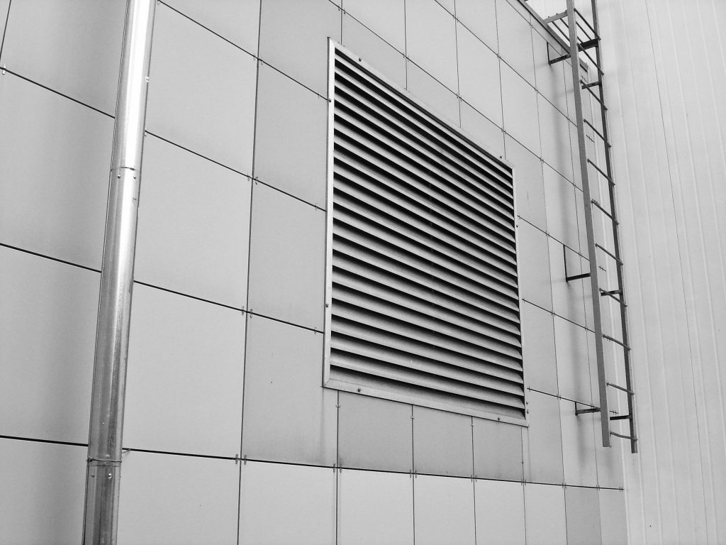 pexels-photo-558632-558632 Close-up of a modern building exterior showing a ventilation system and metal ladder.